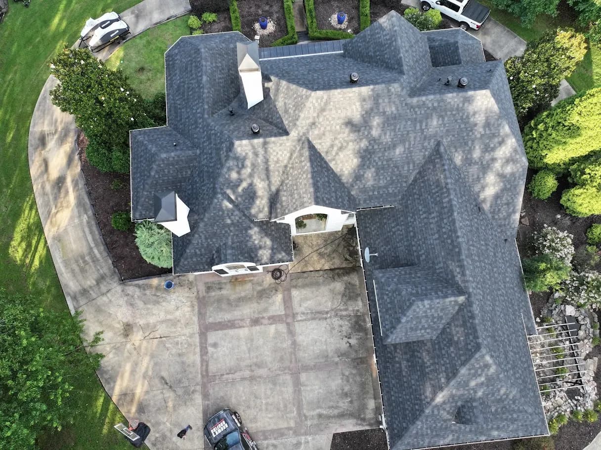 Aerial overhead of a large central Arkansas home with multiple hip lines and a new gray architectural shingle roof